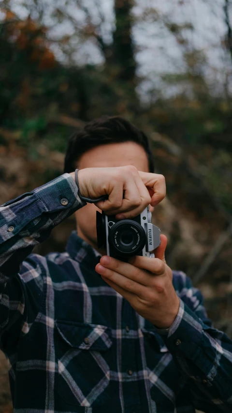 a man standing outside taking a po with his camera