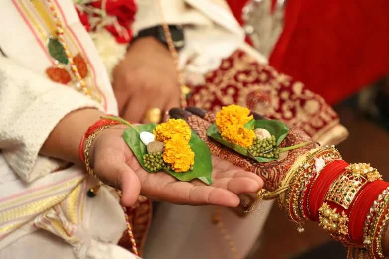 two brides are holding each other small flowers