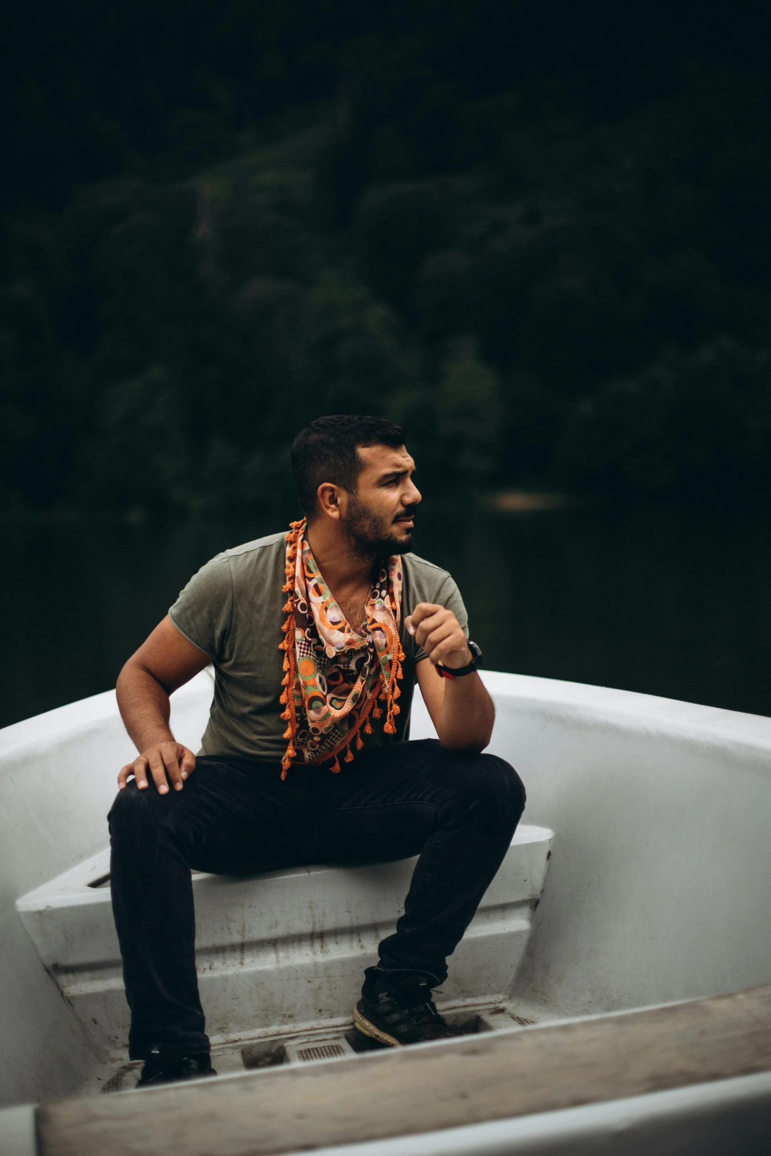 a man is sitting on a boat in the water