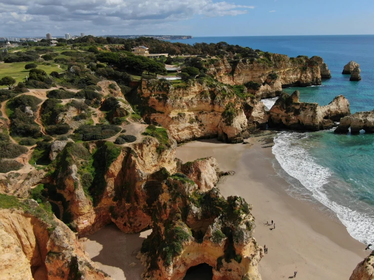 an aerial view of a beach with rocky formations