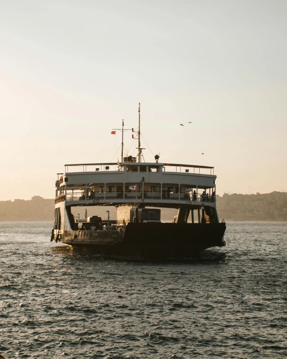 a boat with lots of passengers on a body of water