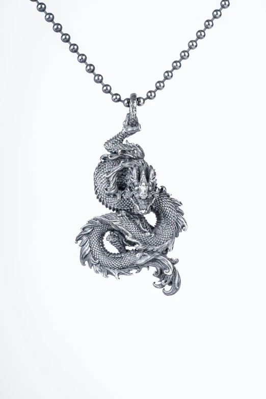 a pendant with a dragon on it