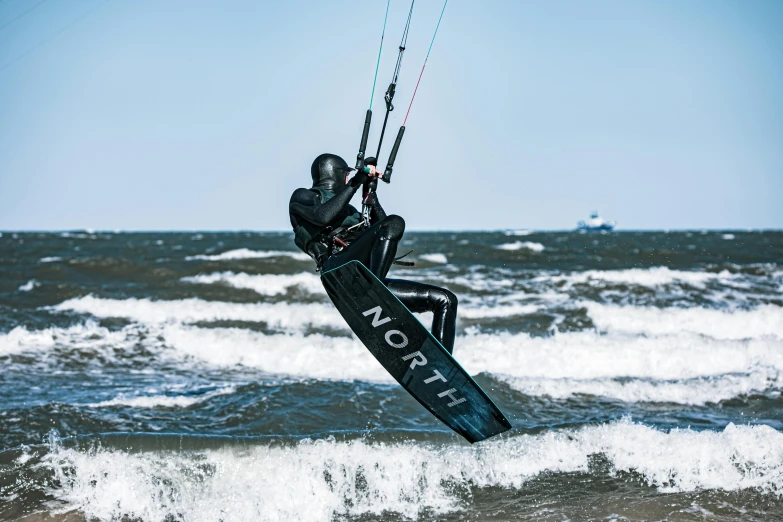 a man is on the water being pulled by a wind surf board