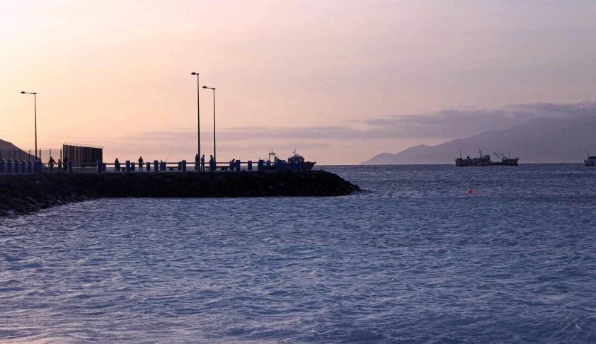 a harbor with a body of water on one side and a boat in the other