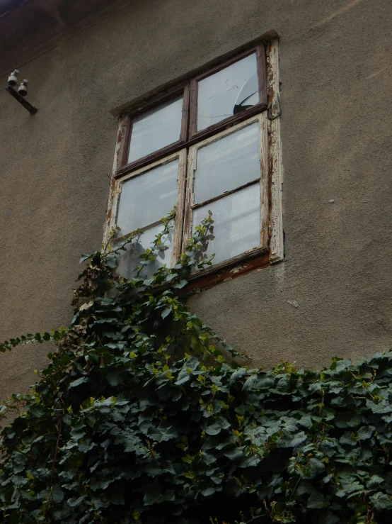 an old looking window is in the side of a building