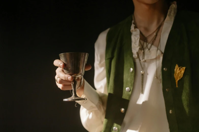 a close up of a person holding a wine glass