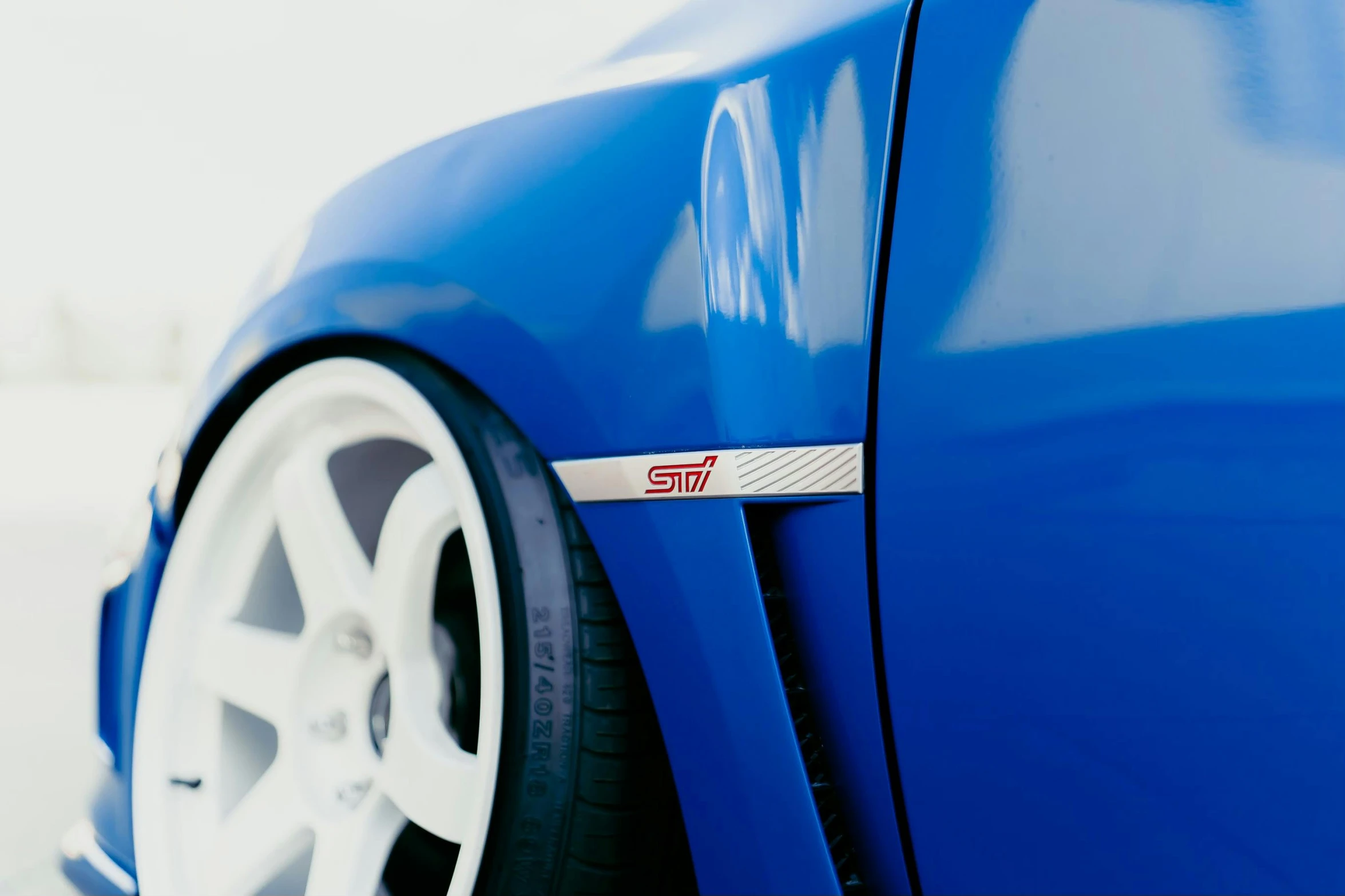 a close up view of a blue car tire