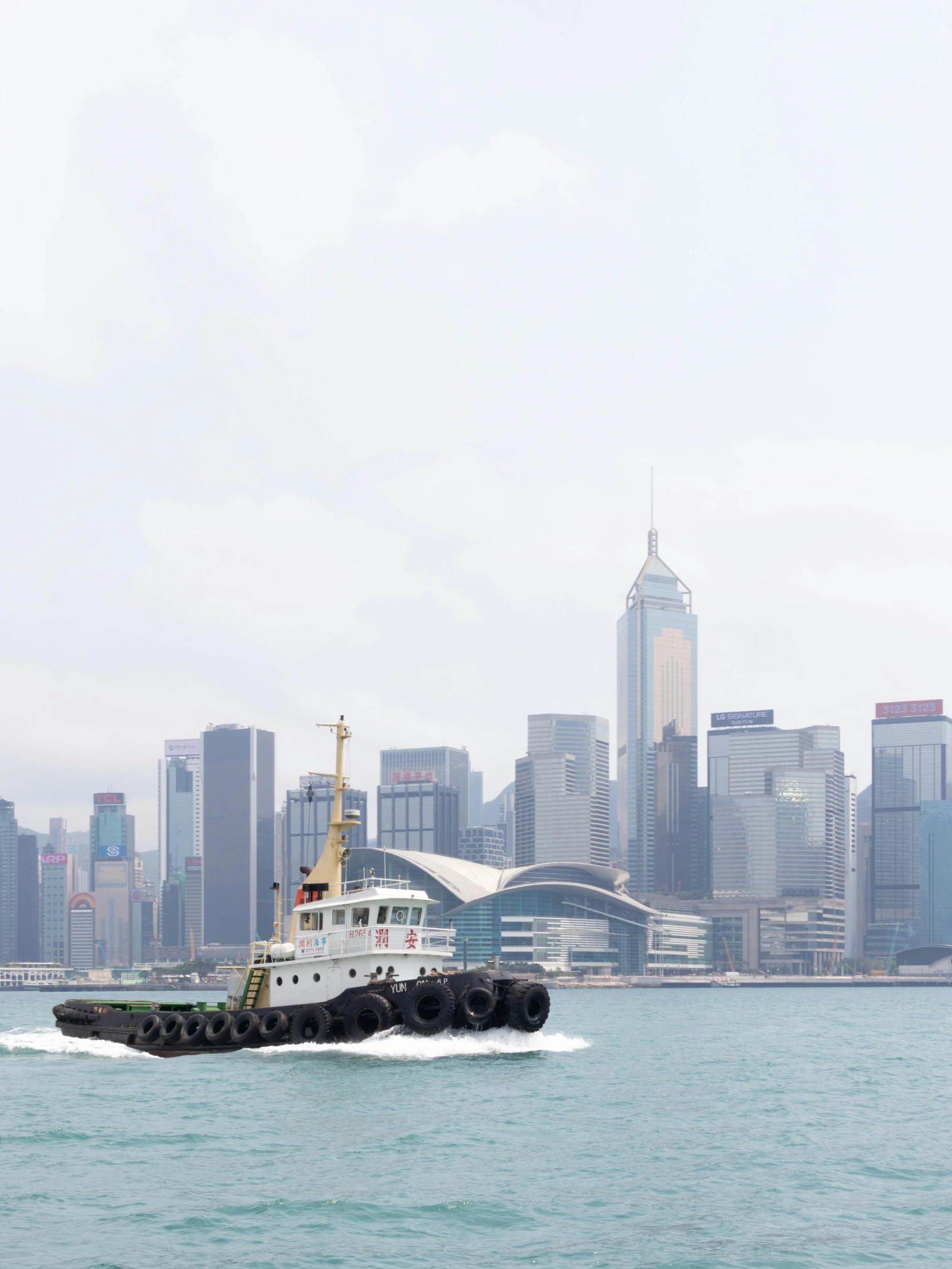 a large boat moving through the water by the city