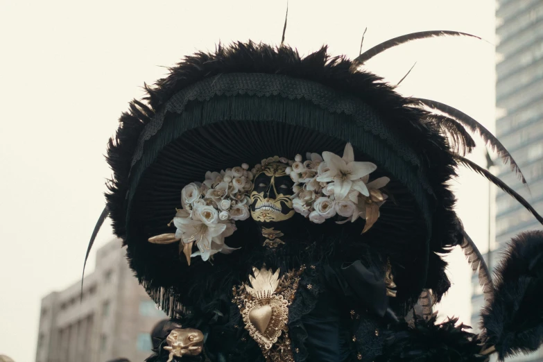 a large headdress with flowers and feathers on it