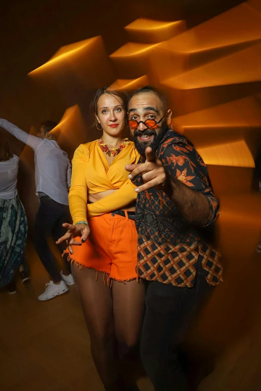 two people with painted faces dance on a brown background