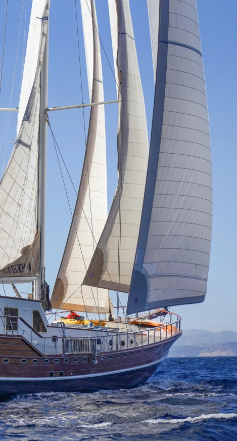 a large boat on the ocean with its sails down