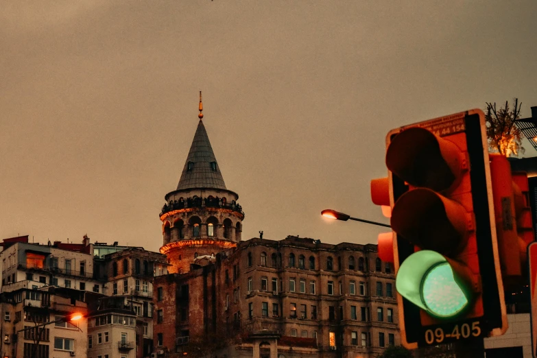 some lights are on and buildings with a clock tower