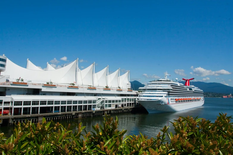 a cruise ship docked at a dock on a clear day