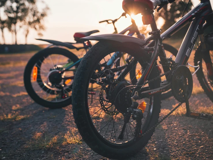 two bikes are sitting parked on the side of a road