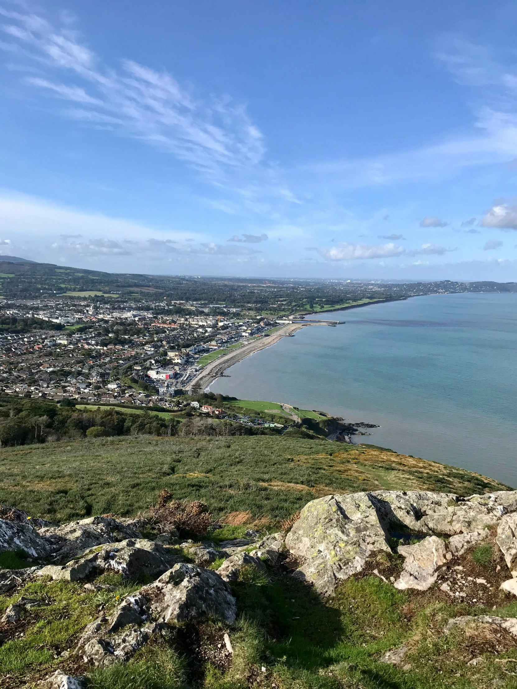 an aerial view of the town in the distance, from above the ocean