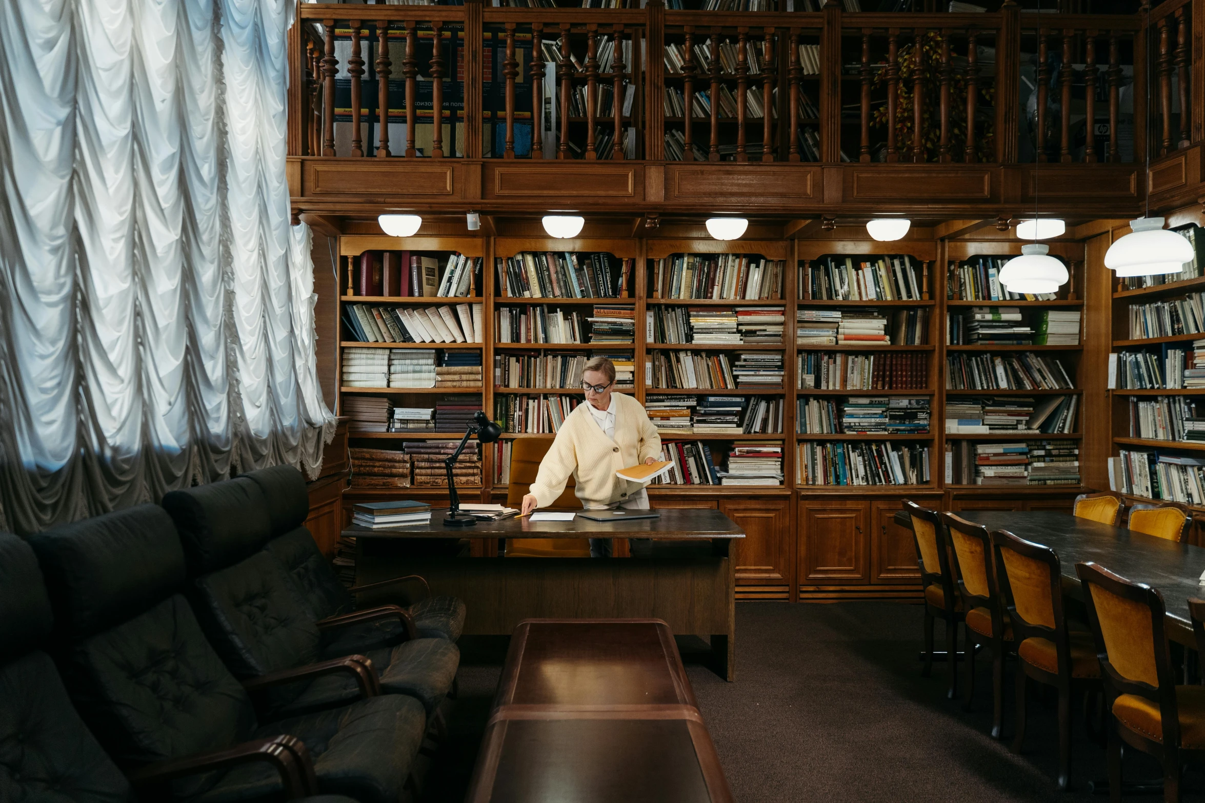 a man sitting at a desk with books in front of him