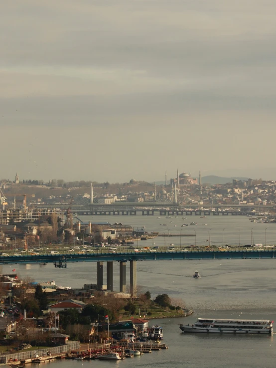 a barge is sailing on the water under a bridge