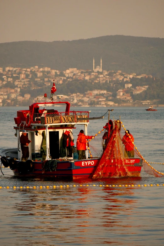 a red and white boat that is going down some water