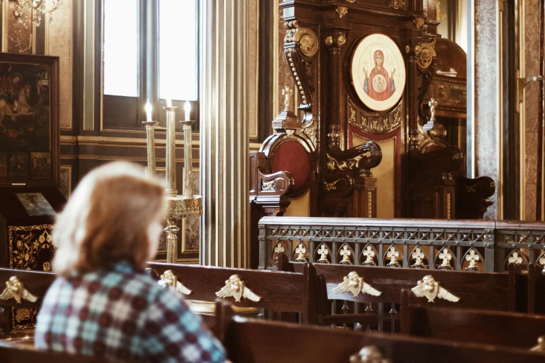 two people sitting inside a church with lots of pews