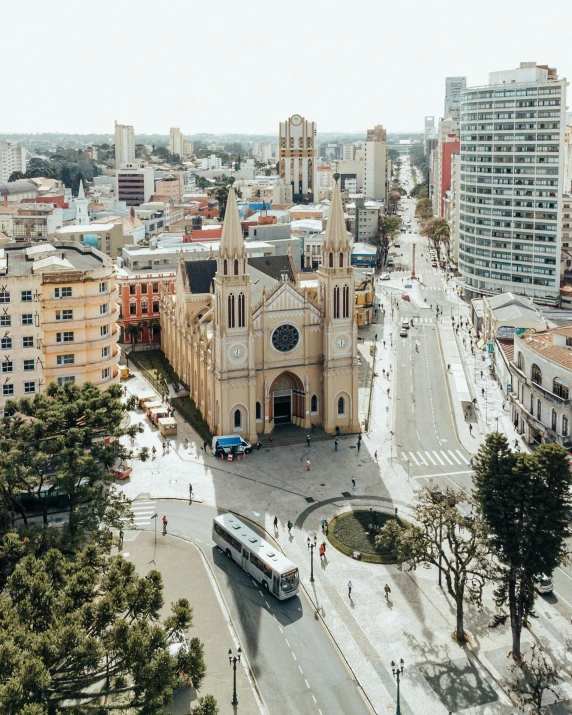 an aerial view of a street with lots of cars driving past