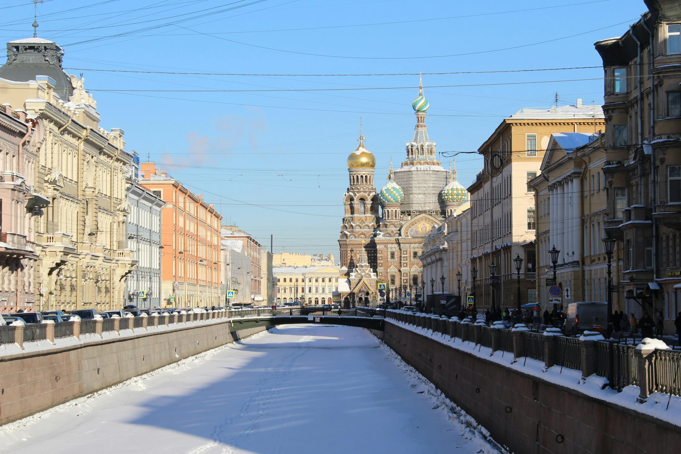 a small canal in a narrow city with snow