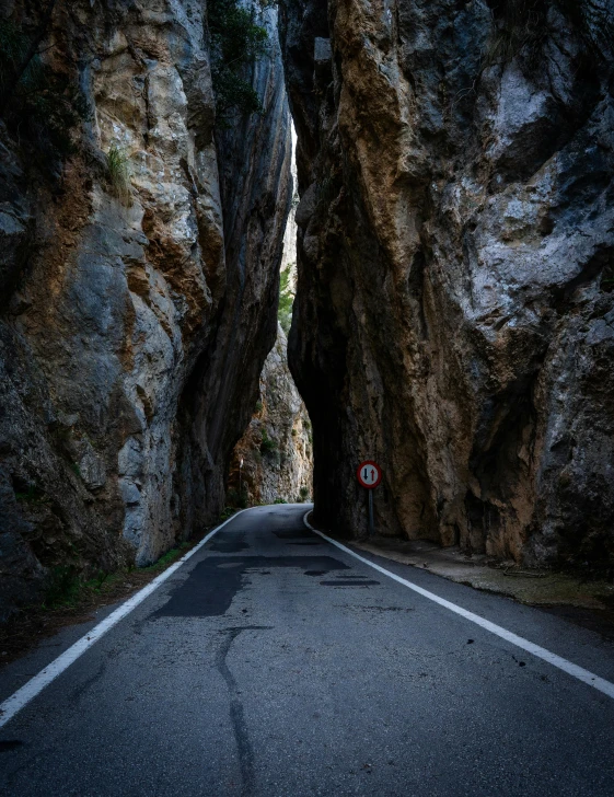 this is a street with some cliffs going up