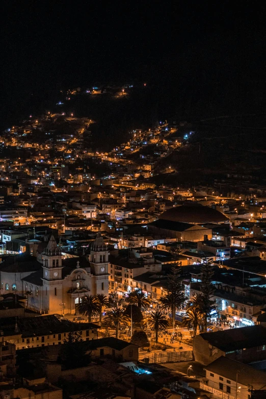 a nighttime scene of town lights and steeples