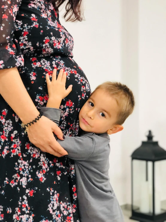 the  is hugging his mother's belly