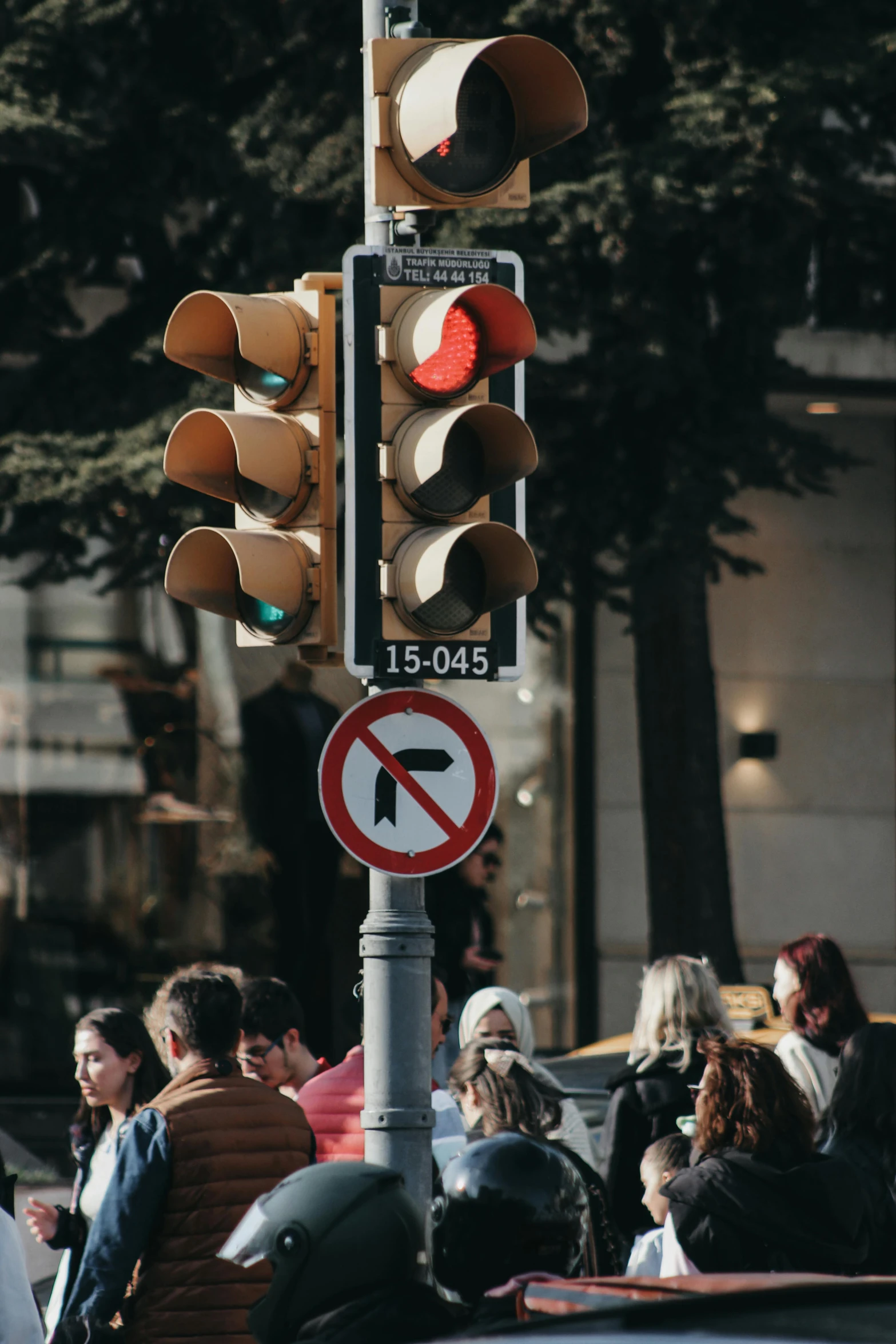 a street light with some red traffic lights on it