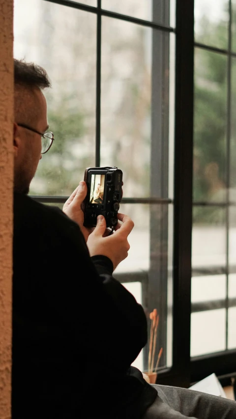 a man takes a picture while sitting down