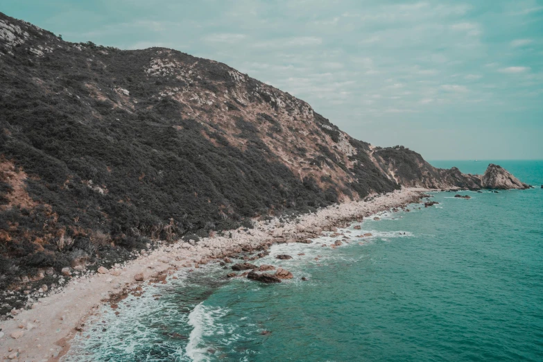 the ocean is serene next to the rocky coast