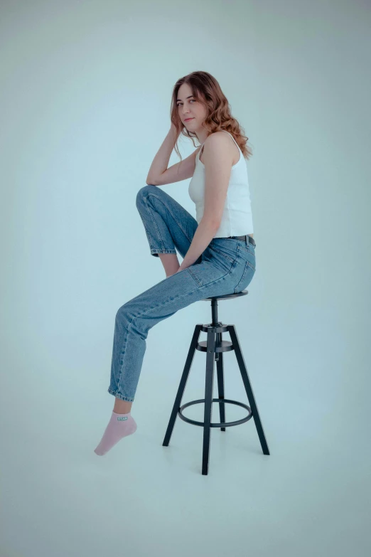 a woman sitting on top of a stool