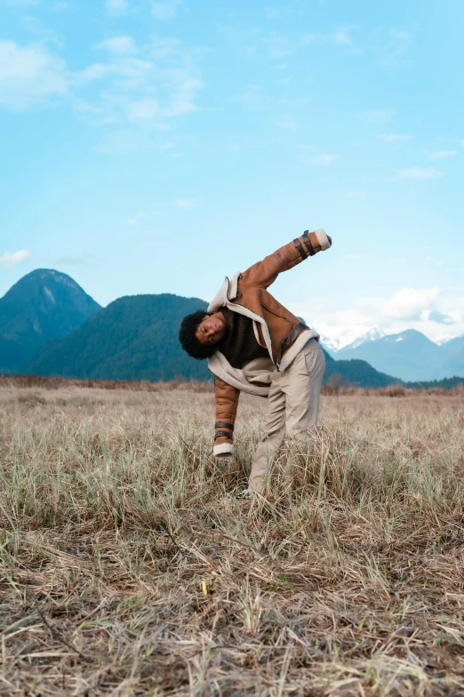 a man in brown pants kneeling on his back