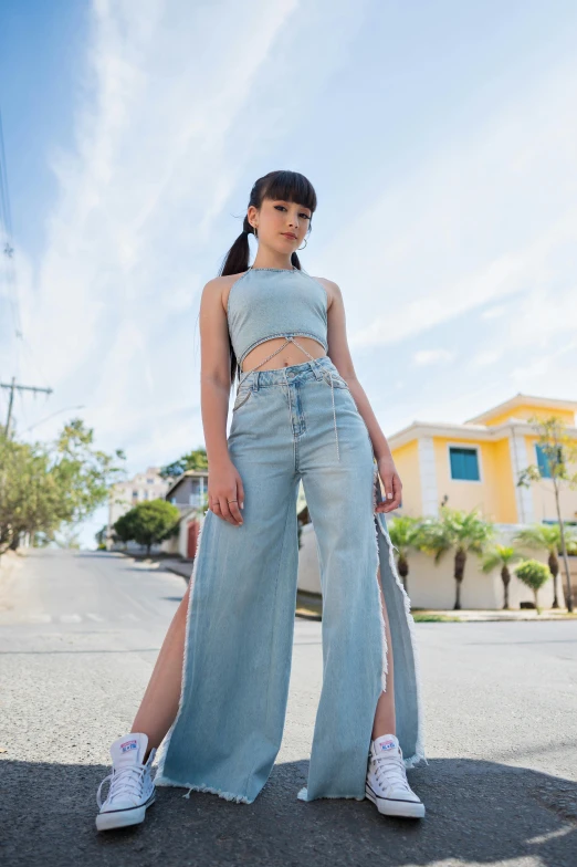 woman standing on the street in front of the camera with her leg up