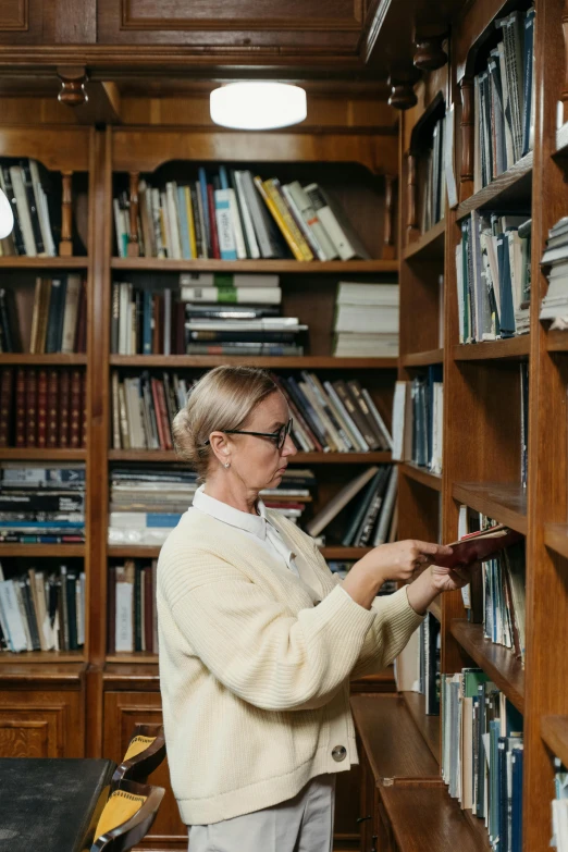 an older woman is browsing the shelves of books