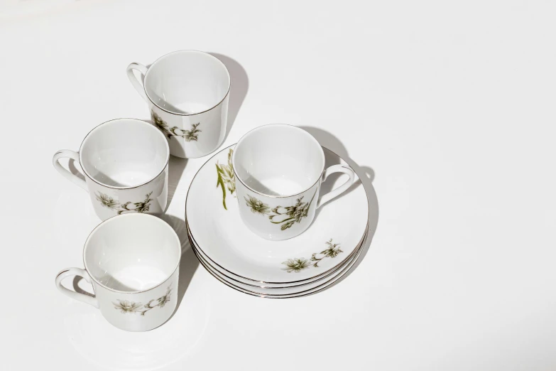 an image of four cups and saucers