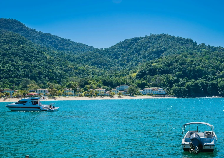 there are boats in the water near the mountains