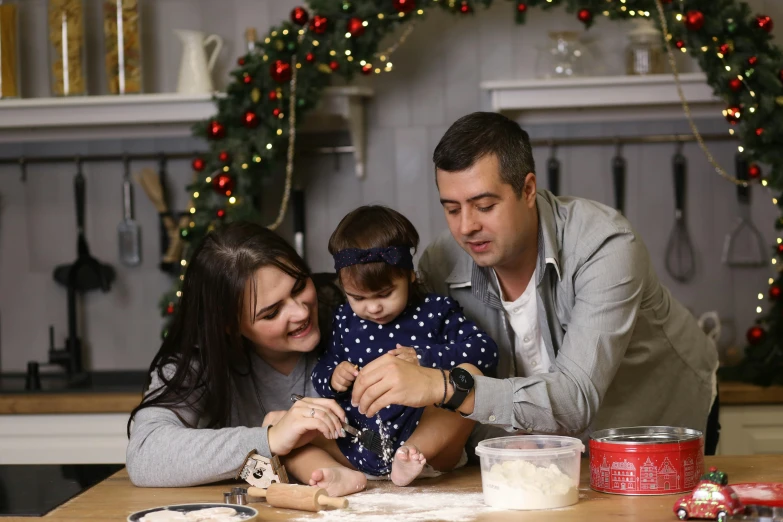 a man with a woman and two children at the table