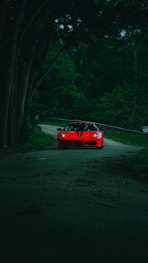 the car is parked at night in a dark forest