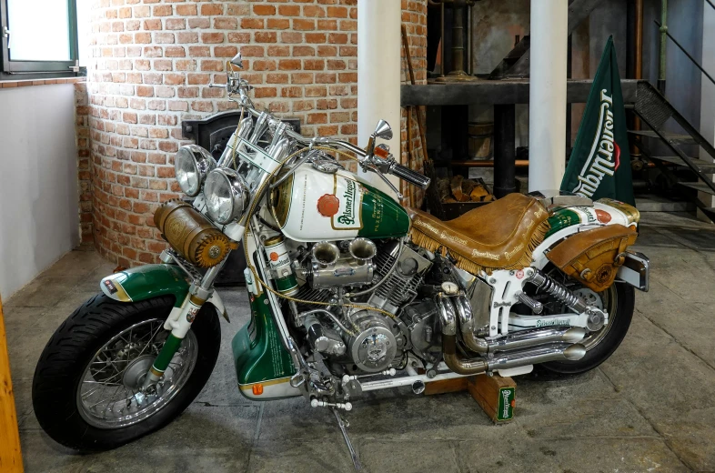 an indian motorcycle parked in a building with a brick wall