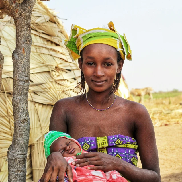 a woman with a baby sitting in her lap