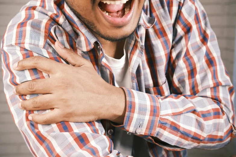 a man making an angry face and holding his arm up