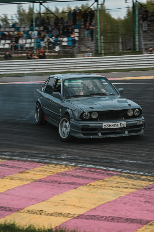 a car with its hood up on the race track