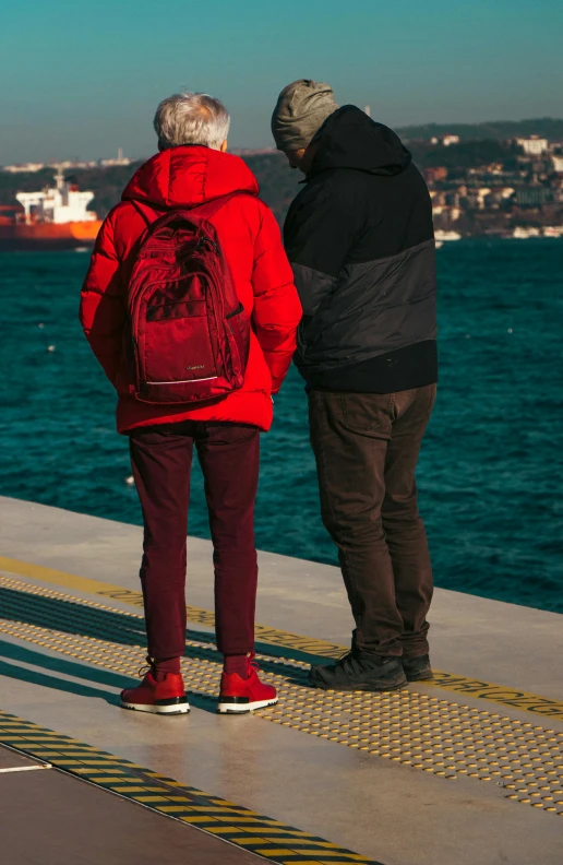 two people looking out over water at the ocean