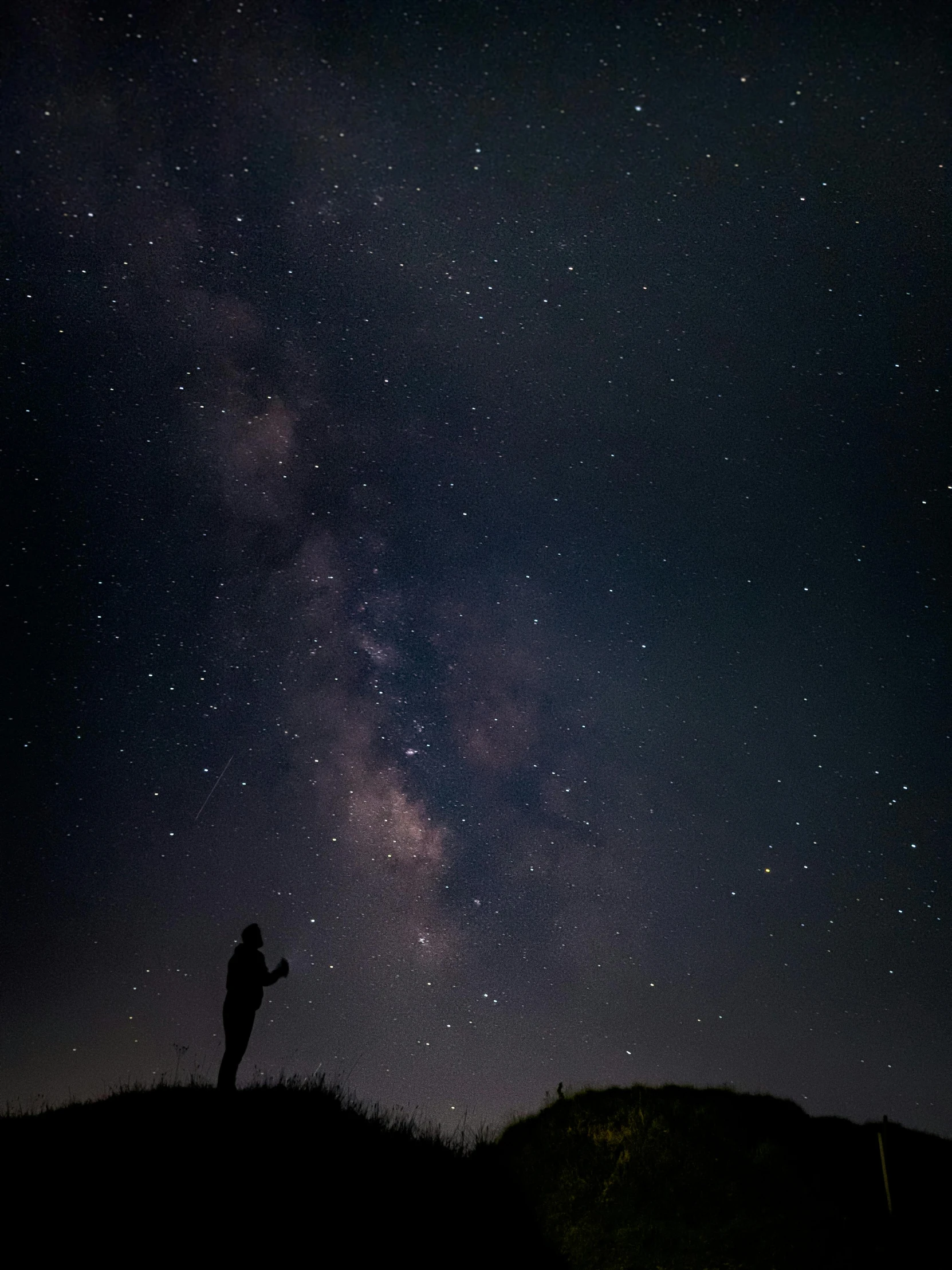 a man is looking at the stars in the night sky