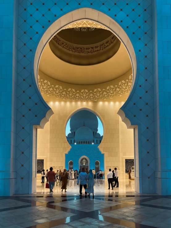 a blue and white building with people in it