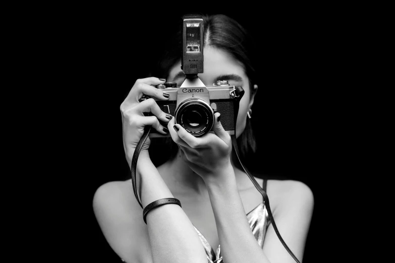 a girl with celets is taking a pograph with a camera
