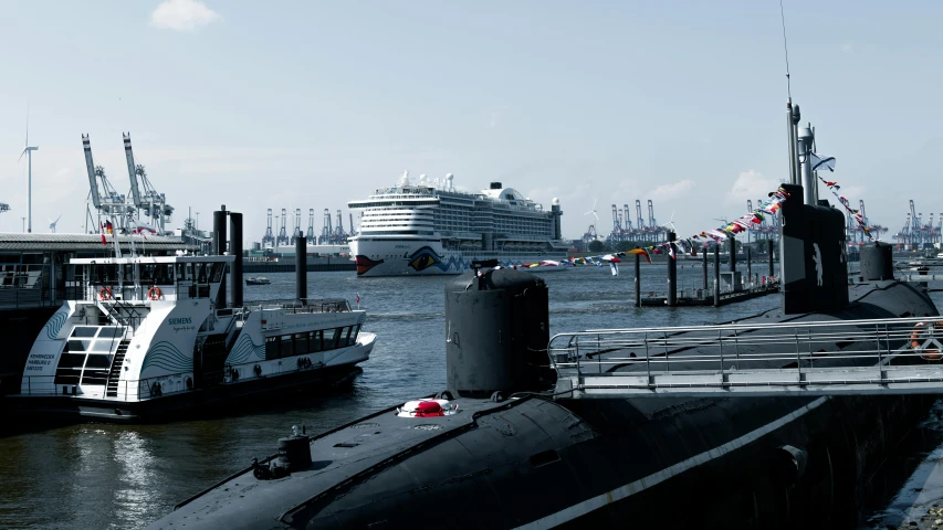 several large ships and a ship in the harbor