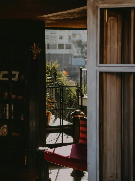 a red chair on the outside deck of a building