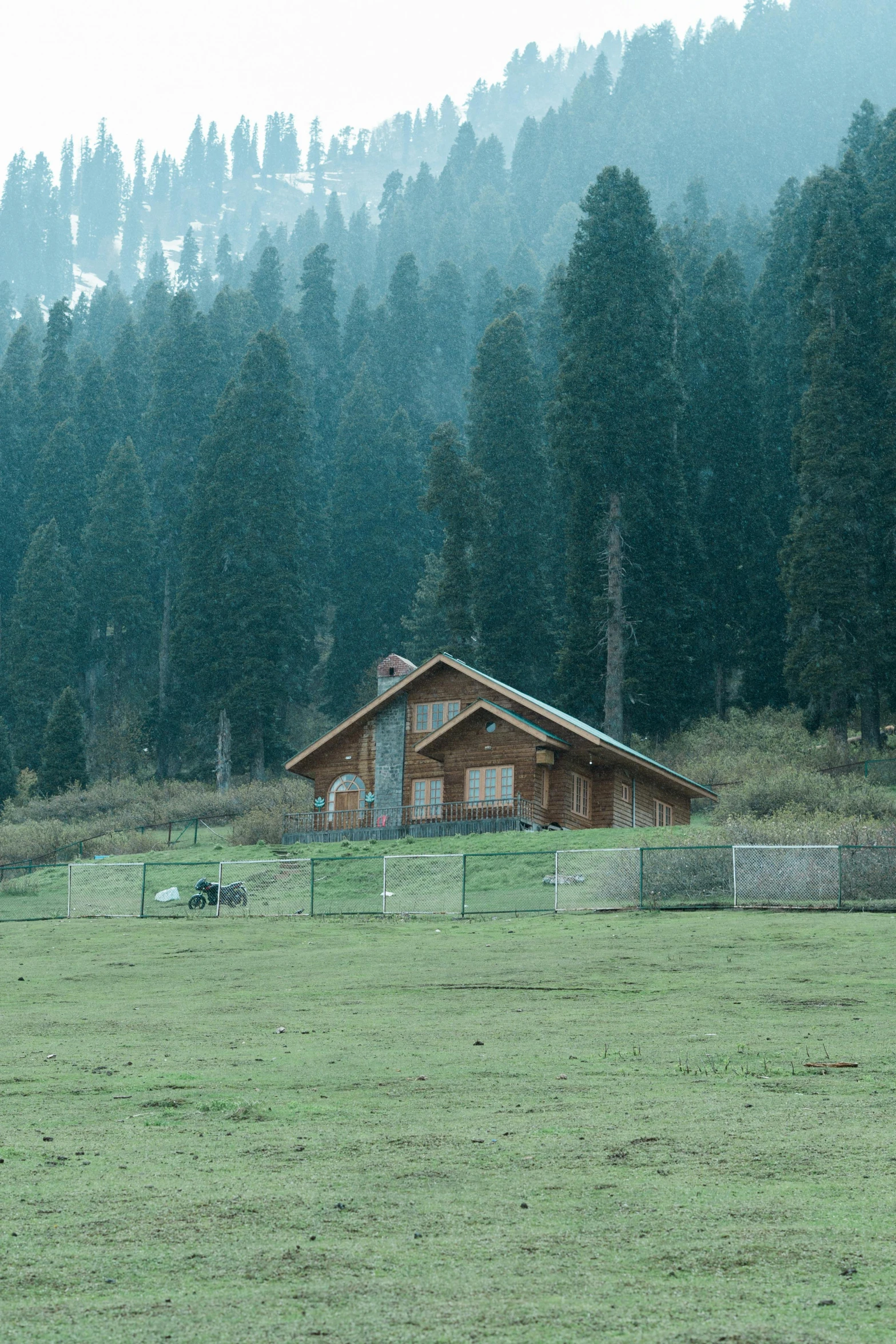 a farm house in the background with sheep nearby